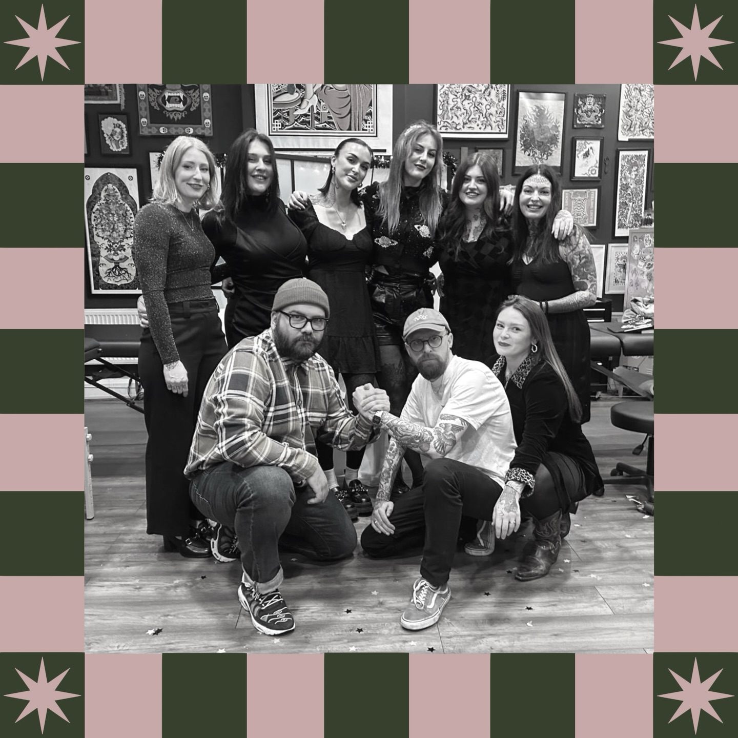 The nine resident artists of Bloom Street Tattoo Studio together in the studio